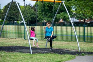 Child and staff on swings