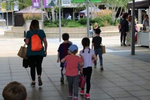 Children and staff walking across campus