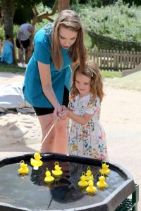 Staff and child enjoying activity