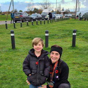 Emma smiling at camera with child